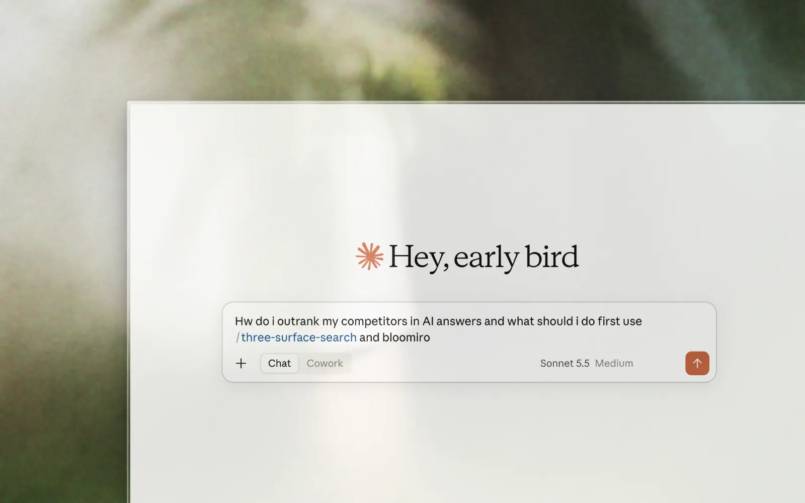 Zoomed chat prompt asking how to outrank competitors in AI answers with three-surface-search and Bloomiro, on a soft blurred nature background